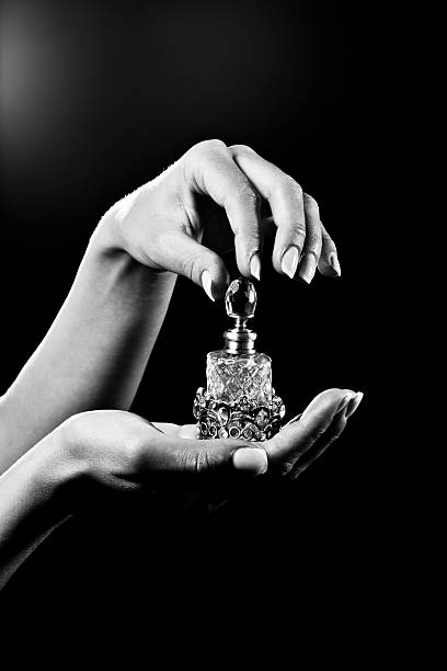 beautiful hands and luxury perfume bottle picture id157605757
